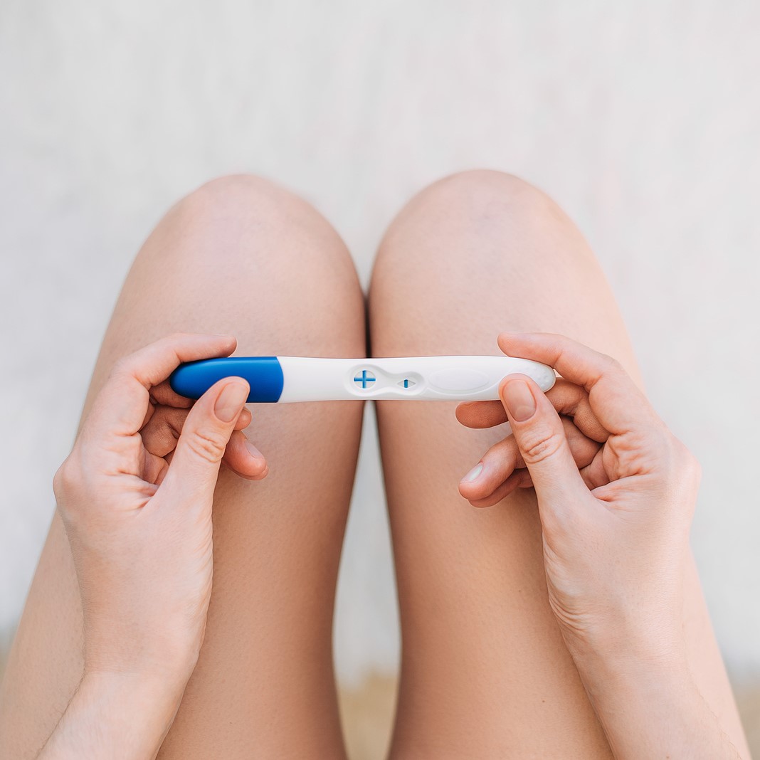 A woman holding a free pregnancy test in Lancaster, California